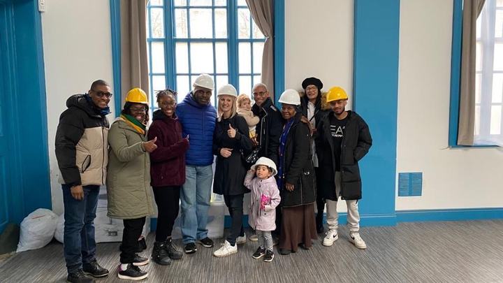 Church members in hard hats inside the community centre